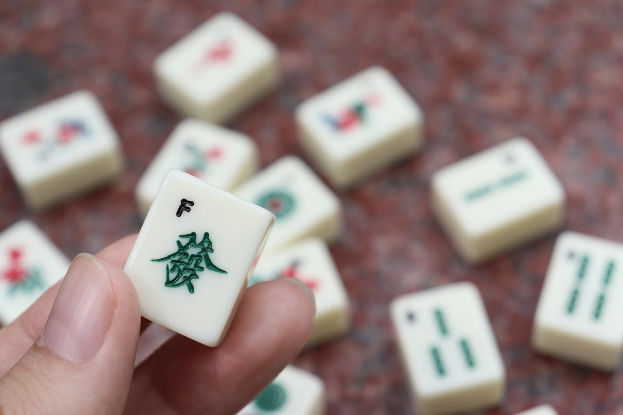 Hand holding up Mahjong tile