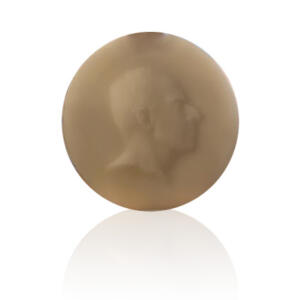 Bronze-gold-colored circle with the hazy profile of a man's face on it.