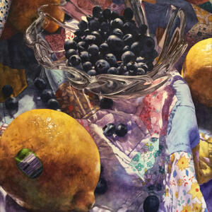 A glass bowl of blueberries and some loose blueberries and oranges on a colorful quilt with sunlight coming from the side.