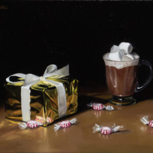 A box wrapped in gold paper and a bow, a cup of hot chocolate with overflowing marshmallows and scattered mints on a table.